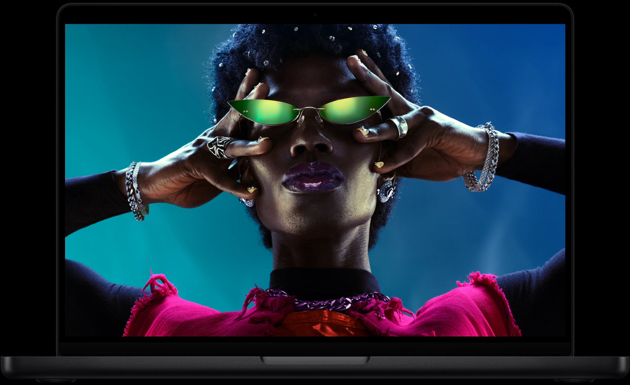 Colorful screen on a MacBook Pro of a person crowd-surfing at a party, showcasing the vibrant Liquid Retina XDR display