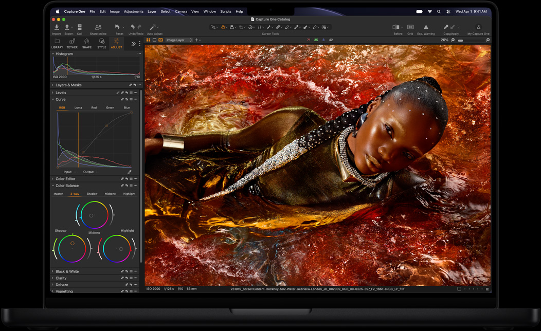 MacBook Pro screen of a photo of a person being edited in Capture One