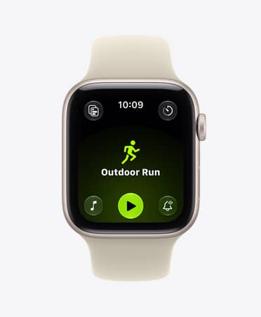 Apple Watch SE 3, aluminum case, starlight color, screen shows Workout app (outdoor run), right side exterior, Digital Crown dial, Sport Band, sand color (pale tan)