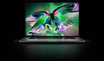 MacBook Pro with PROLED XDR Display, silver color, display shows detailed, high-contrast image with vivid colors, screen illuminates keyboard