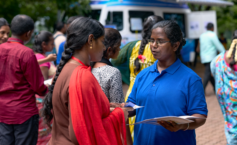 Two people share a conversation at a job fair or event